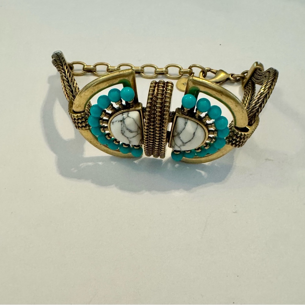 Gold tone bracelet with turquoise beads and howlite stones.